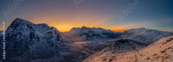 Obraz View into Glencoe, Highlands, Scotland. A lone tent wild camping on the peak over looking Glencoe at sunset.