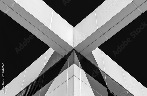 Fototapeta Abstract image of building facade. Architecture detail on exterior building wall. Light and shadow on building wall. Architectural detail and design. Black and white and abstract colors.