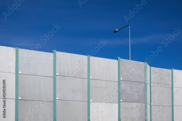 Fototapeta Highway sound barrier and lamppost