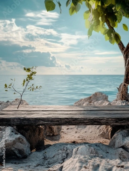 Fototapeta Tranquil beach scene with wooden bench and soft waves under blue sky