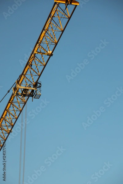 Obraz  Construction Yellow crane against blue sky