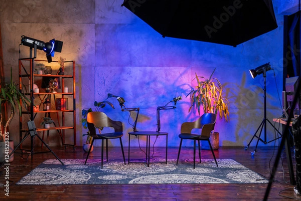 Fototapeta Modern podcasting setup featuring microphones and chairs in a stylish broadcast studio