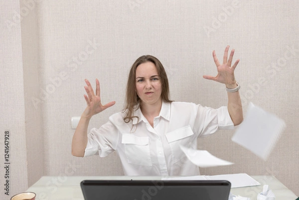 Fototapeta Female person office worker or freelancer works in office or at home at computer. Woman gets angry and throws paper in different directions, she does not succeed in her work, she was tired of working.