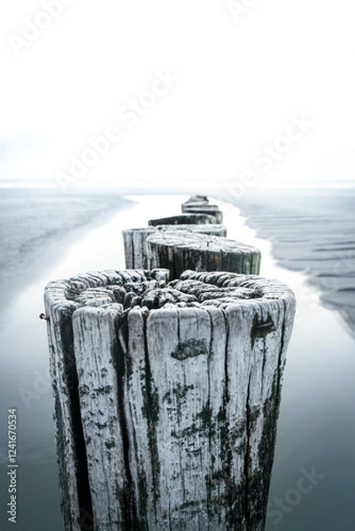 Fototapeta Breakwater with a view of the sea in cloudy weather