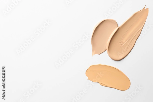 Fototapeta Samples of foundations on white background, top view