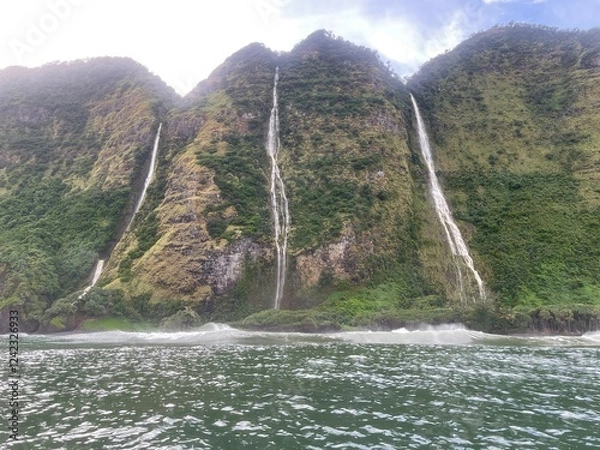 Obraz Waterfalls streaming off huge green cliffs into the ocean below on Hawaii's rugged North Kohala Coast