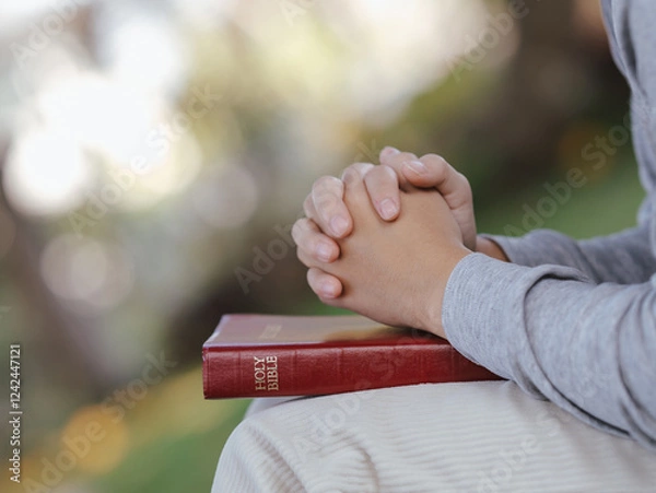 Obraz Asian man praying to God and read the bible at the same time.