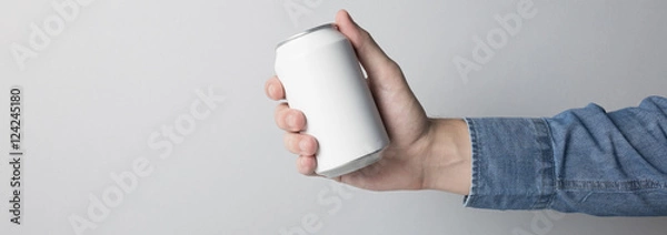 Fototapeta Blank Can in hand on white background, ready to replace your design
