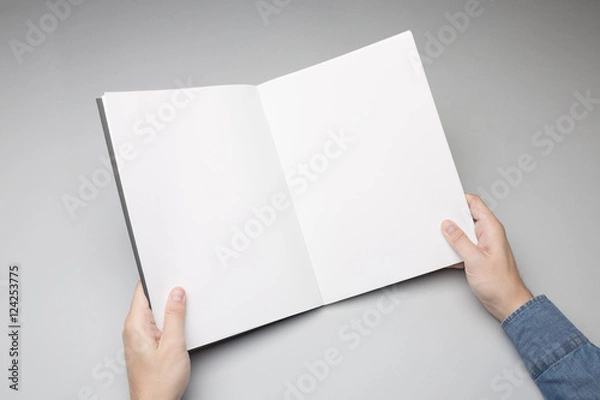 Obraz Hand is holding opened Notebook