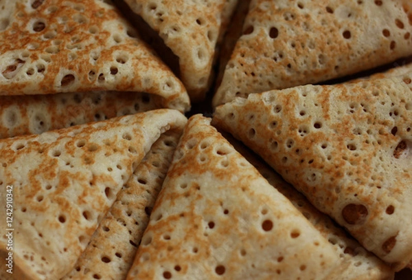 Fototapeta baked pancakes openwork in a hole triangles close-up