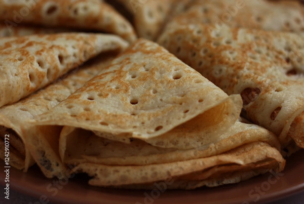 Fototapeta baked pancakes openwork in a hole triangles close-up