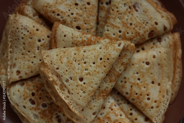 Fototapeta baked pancakes openwork in a hole triangles close-up