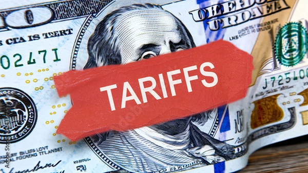 Fototapeta American Tariffs Label on a Hundred Dollar Bill, Bold 'TARIFFS' Text Overlaying U.S. Currency, Symbolic Representation of Economic Impact, High-Resolution Detail on Bill's Design, Financial and Trade 