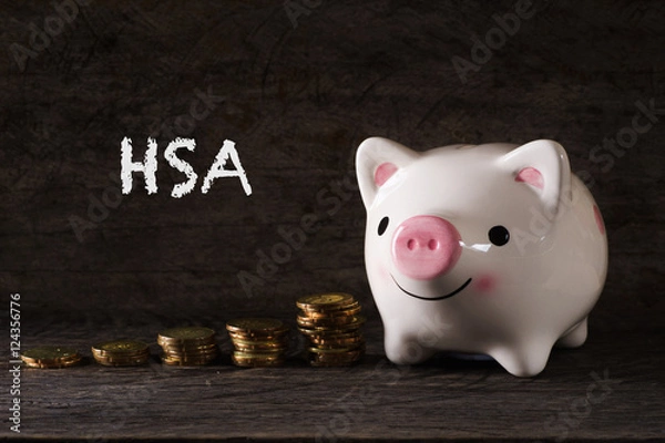 Fototapeta HSA" words Piggy bank and stack of golden money increased with wooden background - saving, finance and business concept