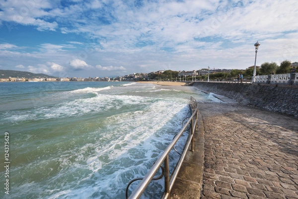 Obraz Tourist walking in the promenade of La Concha beach in San Sebastian bay, Basque Country, Spain.