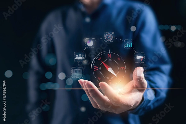 Fototapeta Compass for navigation, direction of business strategy to achieve the highest goal,  of personnel control, scheduling and public relations, businessman set the compass to guide to success. Dark tone