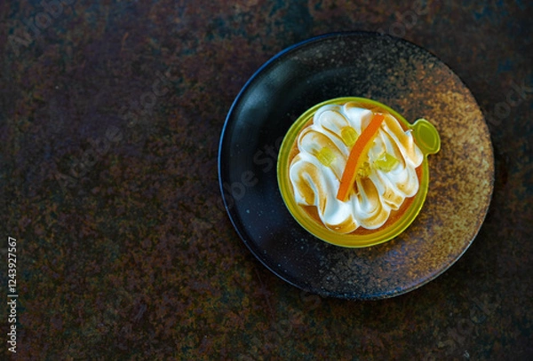 Obraz Orange meringue tart on a rustic plate.