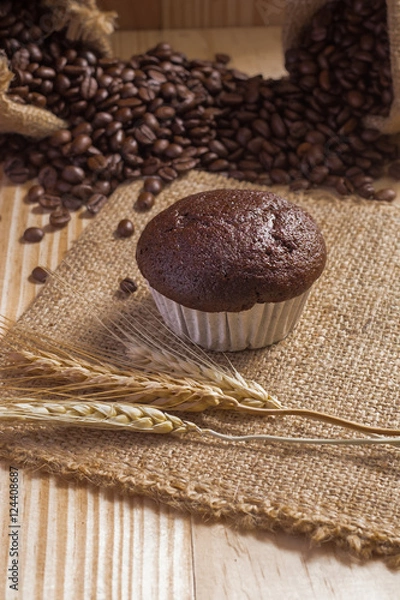 Obraz Cupcake on fabric  with coffee beans background.
