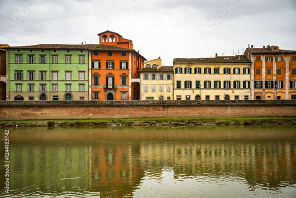Fototapeta View on Arno river and colorful building, reflection in water, Pisa, Italy