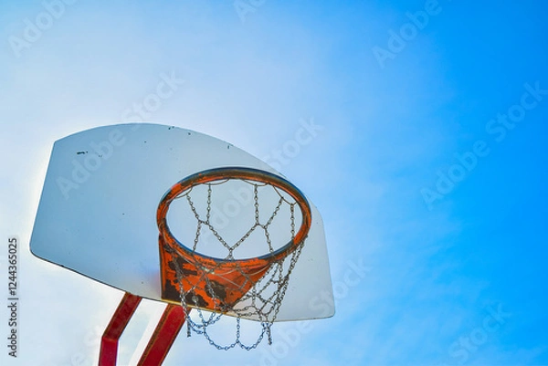 Fototapeta Basketball hoop net isolated on a clear blue sky background. Bright vibrant colors. Angled composition. Copy space for text.