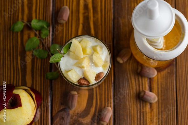 Fototapeta sweet homemade yogurt in a glass with apples, nuts and honey