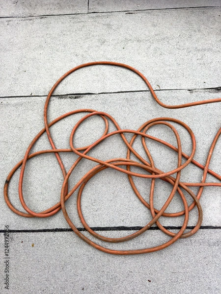 Obraz Old water hose pilled up on the roof