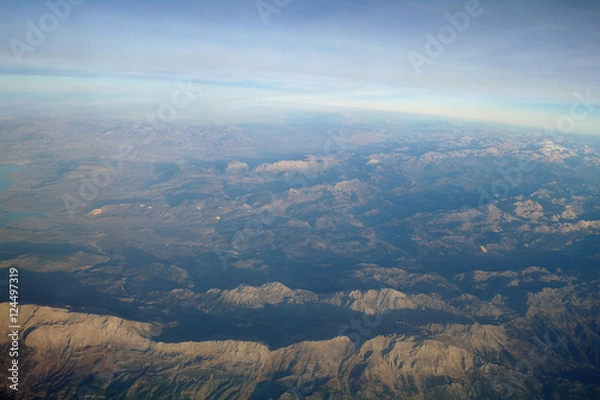 Obraz Aerial view above clouds and landscape