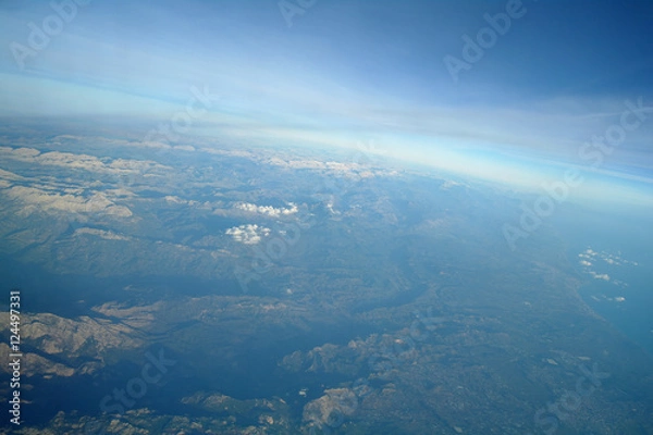 Obraz Aerial view above clouds and landscape