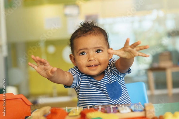 Fototapeta Happy baby playing with toy blocks.