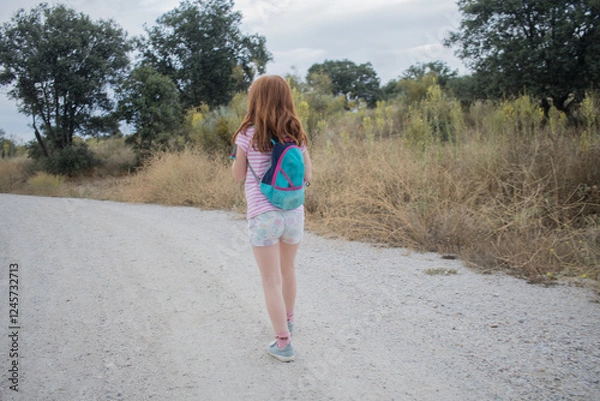Obraz  girl, hiking field with backpack. child backpacker walking in nature. Summer. Horizontal