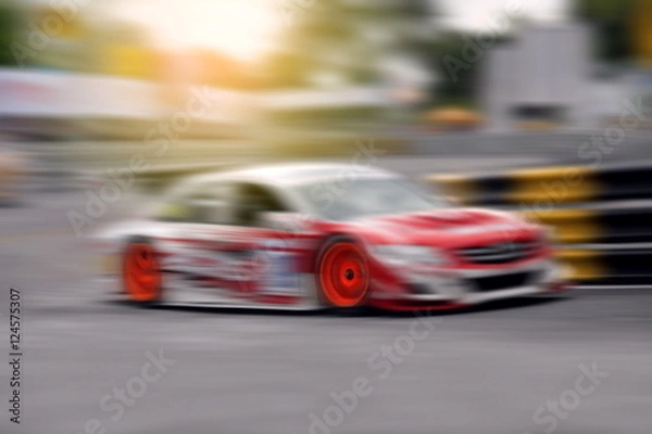 Fototapeta Race car racing on speed track with motion blur