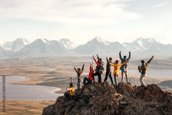 Obraz Large group of tourists diverse people hikers are standing at mountain top at winner poses with open raised arms and enjoys achievement