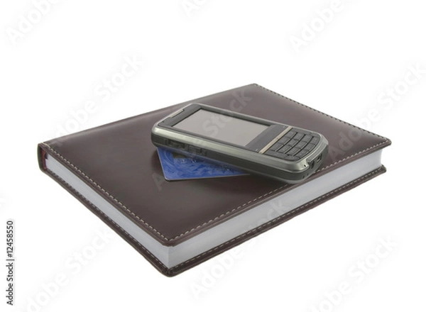 Fototapeta Closeup of brown notebook.credit kard and mobile phone on it iso