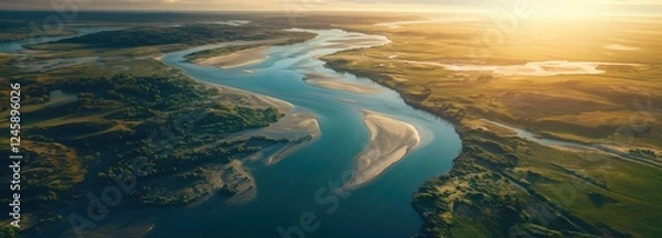 Obraz Winding river flowing through serene landscape at sunset aerial view