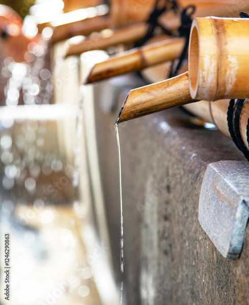 Fototapeta Chozuya or temizuya for the purification ceremony with bamboo pipes and running water at Fushimi-inari Shrine in Kyoto
