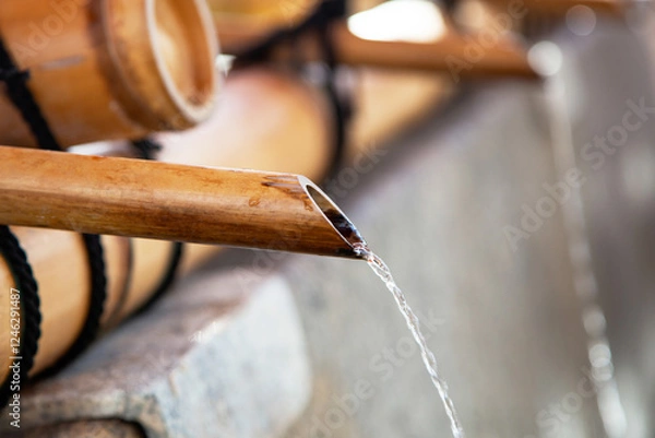 Fototapeta Chozuya or temizuya for the purification ceremony with bamboo pipes and running water at Fushimi-inari Shrine in Kyoto