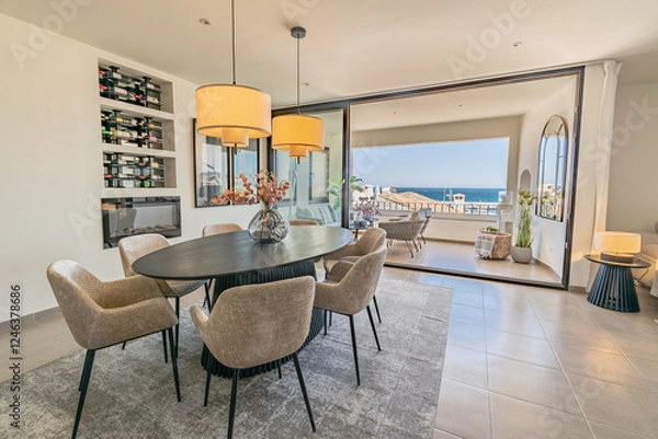 Obraz a large dining table next an open balcony terrace in luxury apartment overlooking the port town of Puerto Banus 