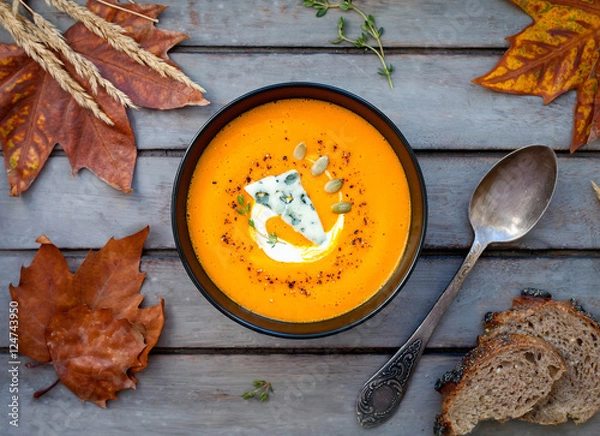 Obraz Pumpkin soup a wooden table.