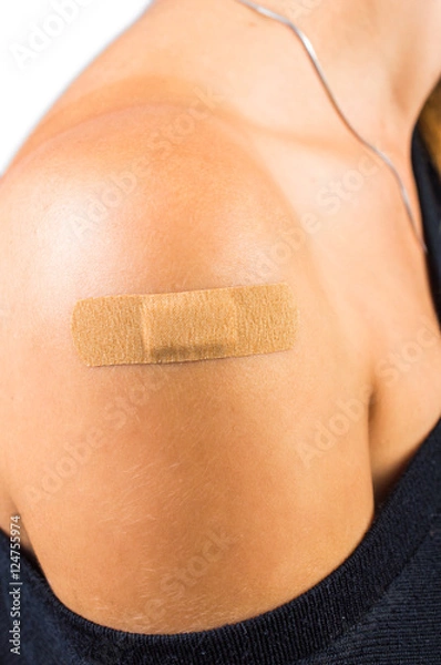 Obraz medical plaster on her shoulder. On white, isolated background.