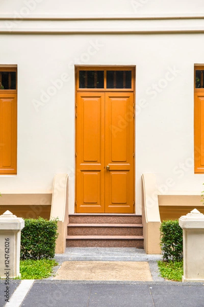 Obraz orange Door , orange window on Cream Wall on orange staircase wi
