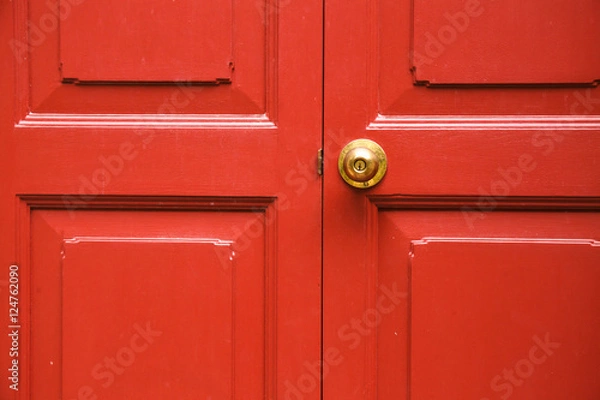 Obraz Door knob golden color with red door background
