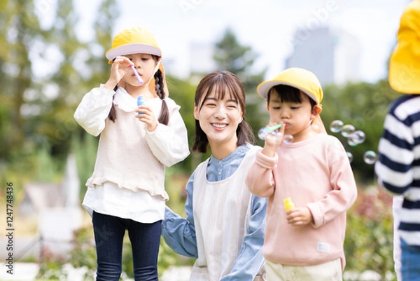 Obraz 公園で遊ぶ保育士と園児