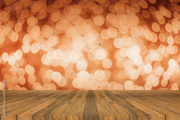 Fototapeta Wooden board empty table in front of light out of focus blurred background. Perspective brown wood over bokeh, can be used for display or present your products.Mock up your products