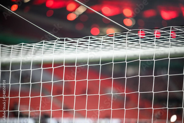 Fototapeta Close-up of a football soccer net on a stadium background.