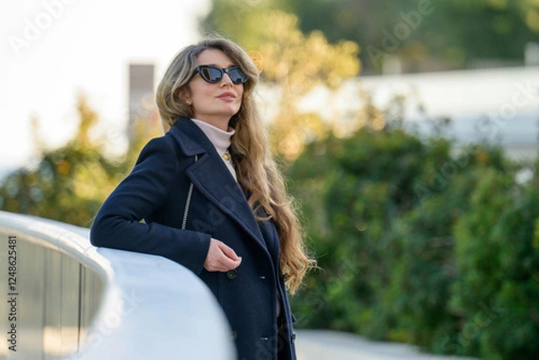 Obraz Woman in black sun glasses posing in Monaco near the beach, winter clothes, long hair
