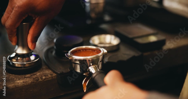 Fototapeta Coffee, portafilter and hands with person, waiter and barista service in cafe with employee for caffeine process. Grounded beans, metal weight and roasted blend for morning brew, hot drink or latte