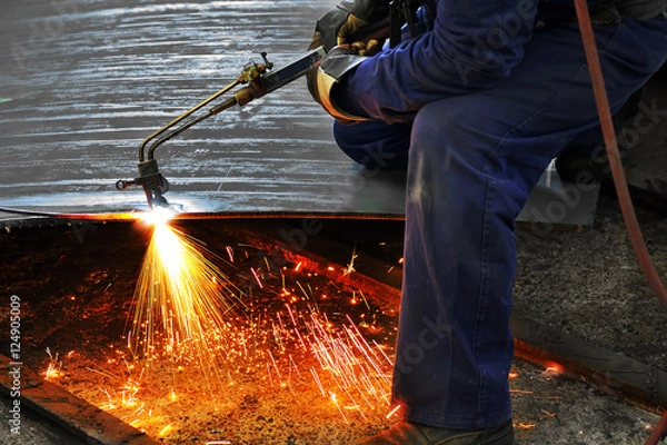 Fototapeta a welder working at shipyard in day time