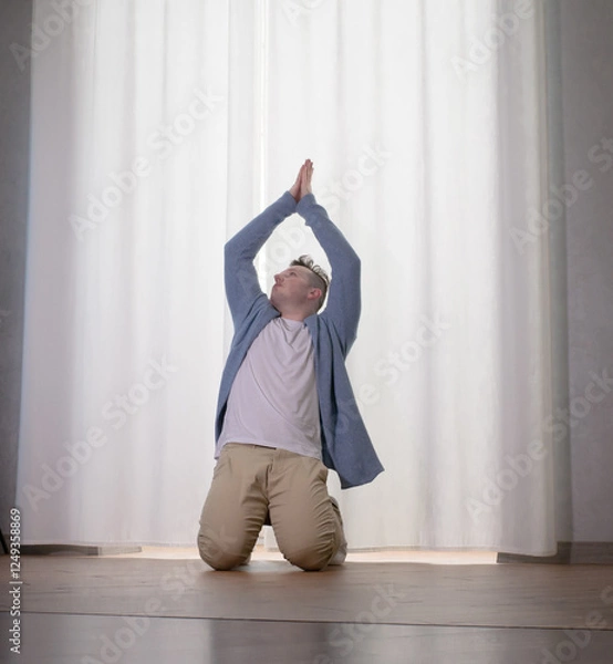 Obraz Young guy dancer in motion in a pose. A man performs a modern dance in casual clothes.
