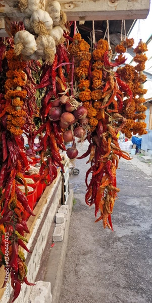 Fototapeta Garlic, onions, chilis, peppers and other colourful spices on a market in Tbilisi, Georgia.