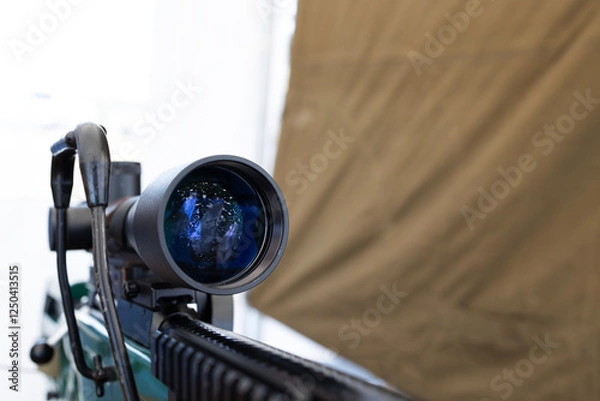 Fototapeta Sniper scope on a rifle close-up . War concept . Copy space